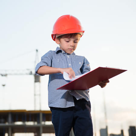 Young man in a hardhat with a clipboard